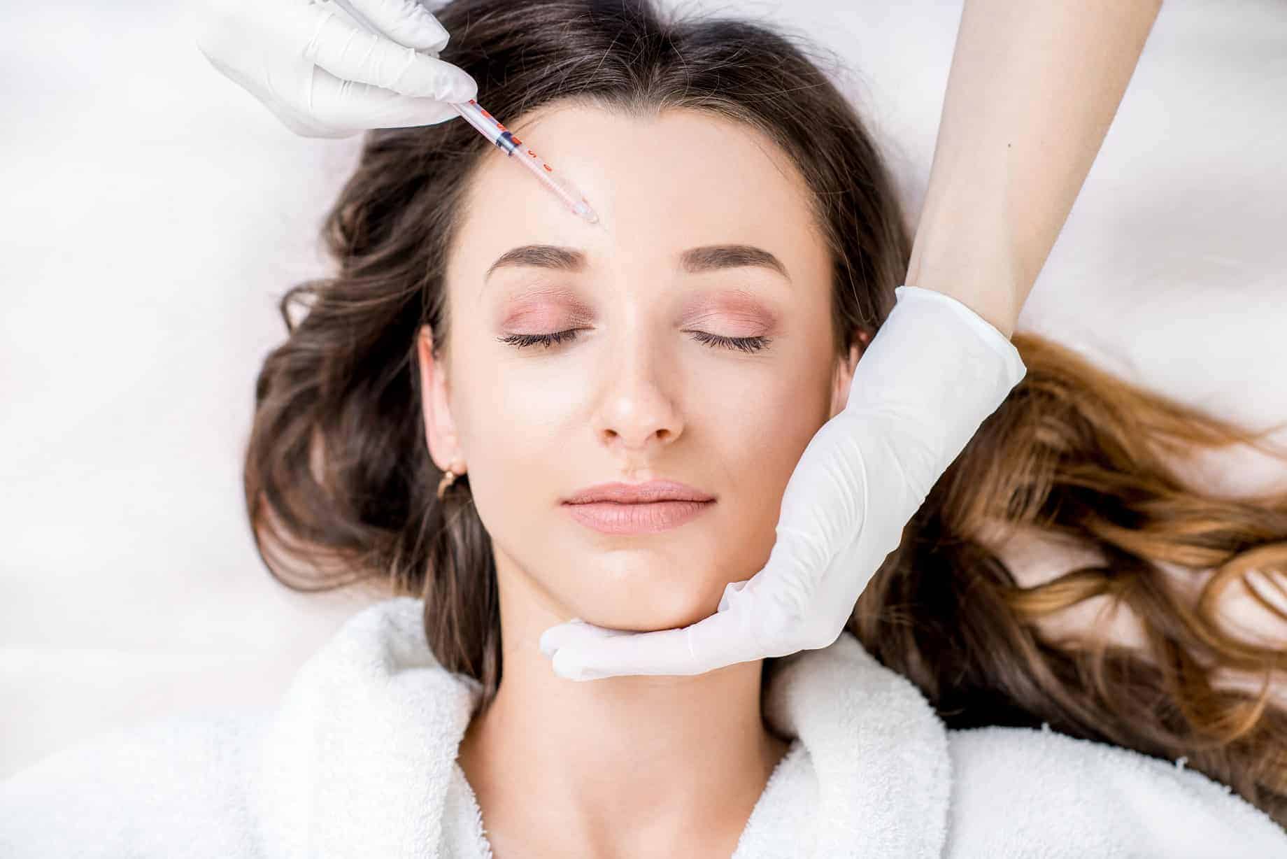 a woman receiving a botox injection