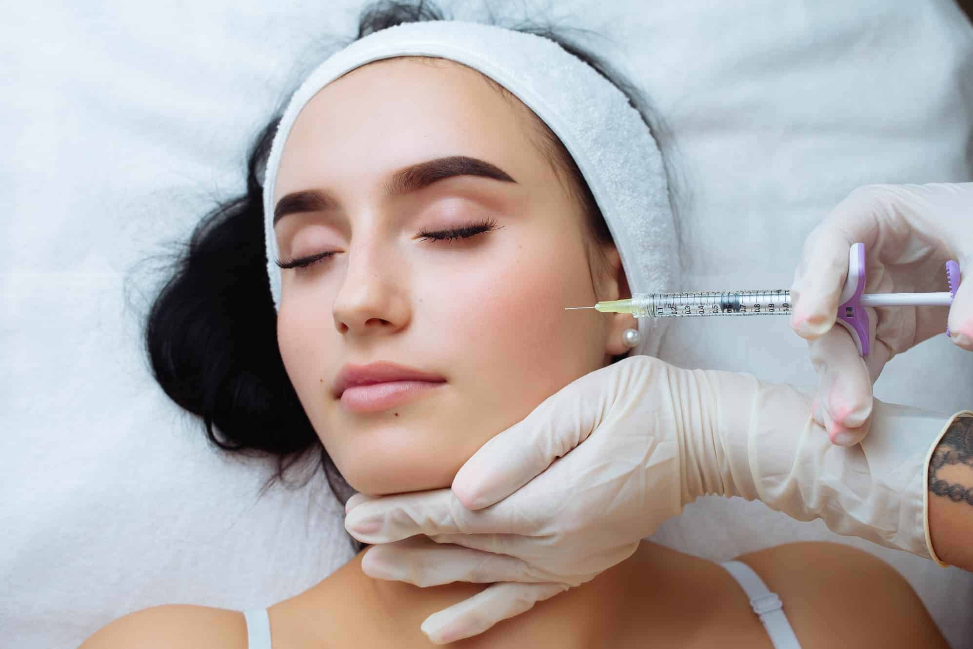 a woman receiving a botox injection