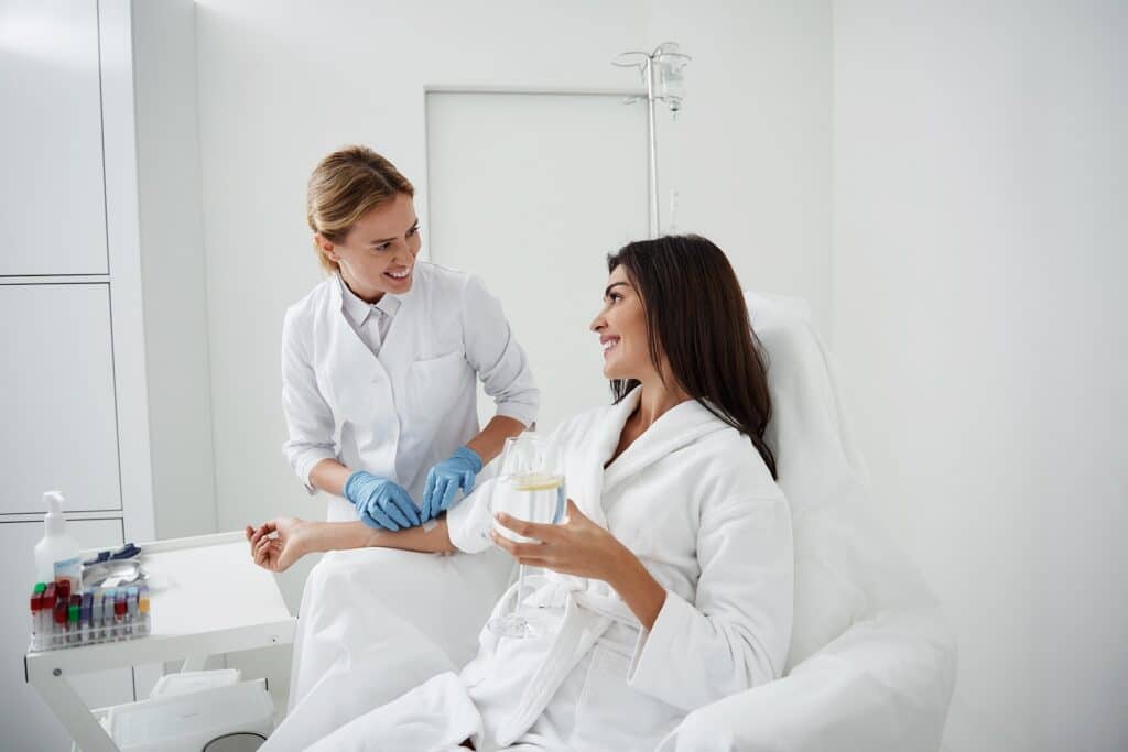 Portrait of charming woman sitting in armchair getting IV and IM Injections | ReViVe Aesthetics and Healthcare in Rockwall, TX