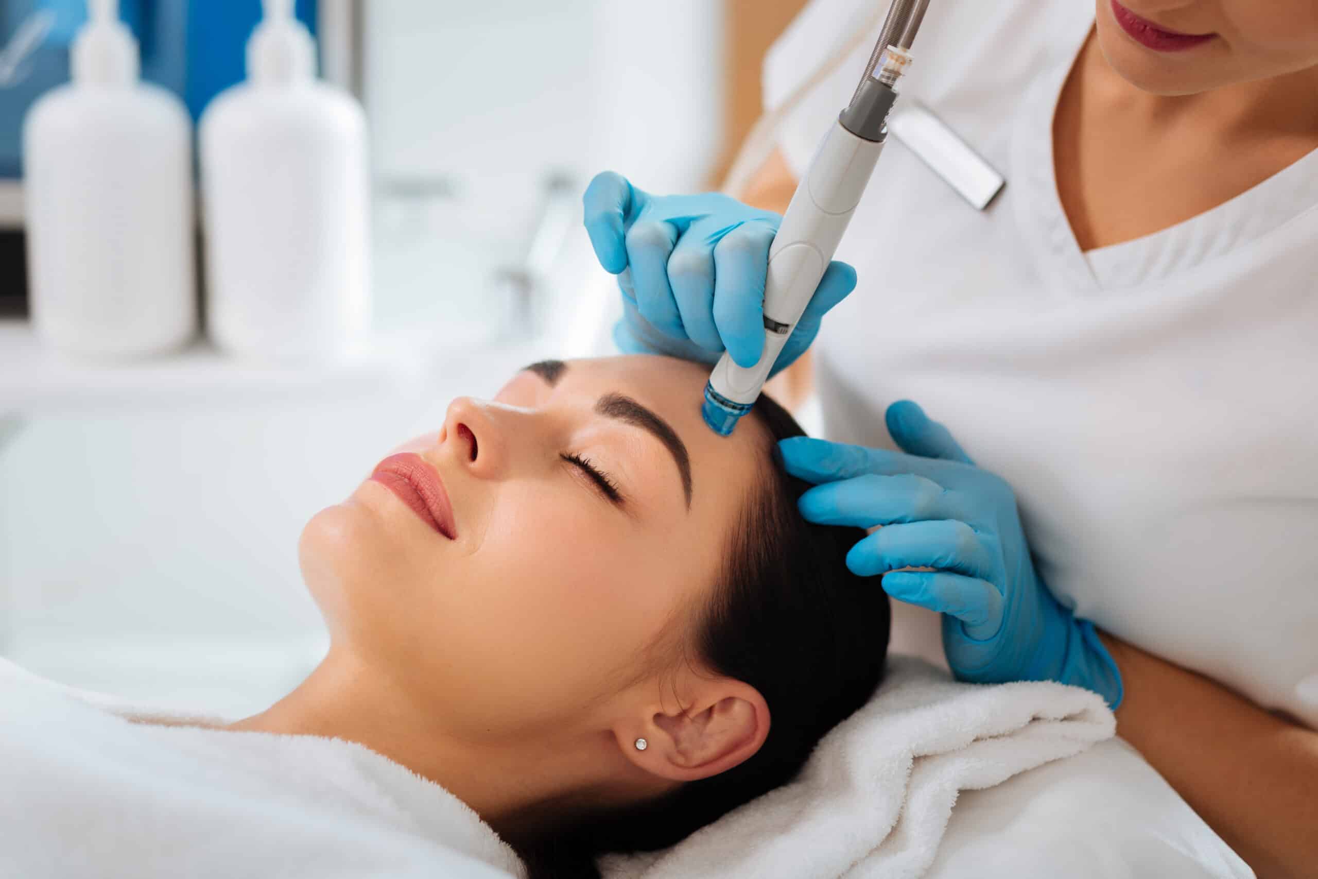 a woman receiving a facial treatment