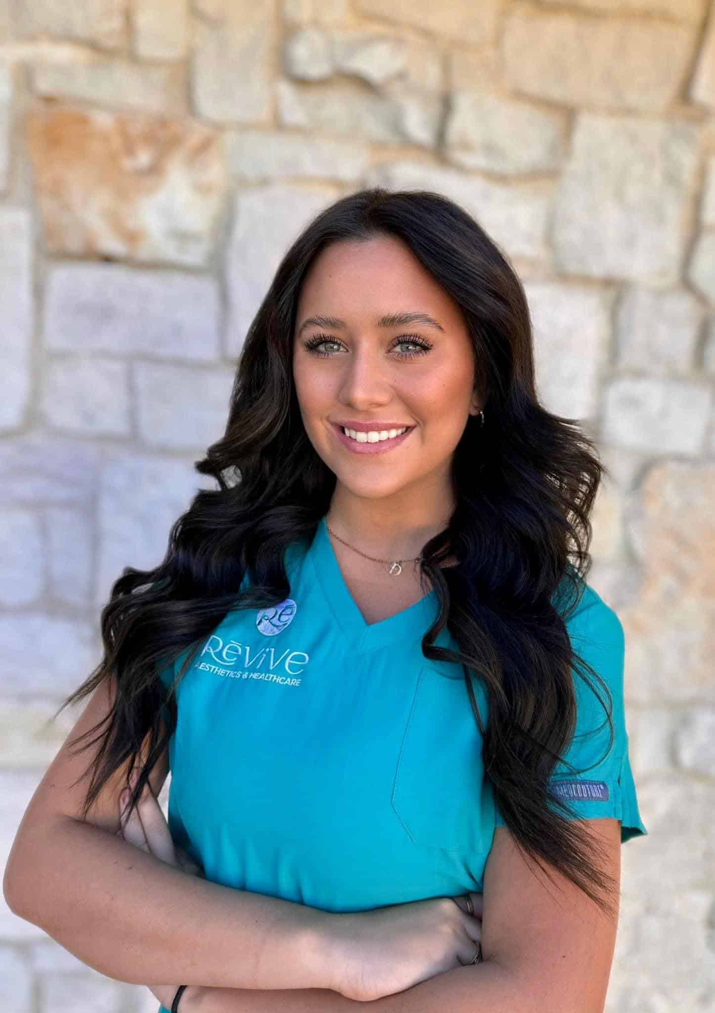 a woman with long hair wearing a blue shirt