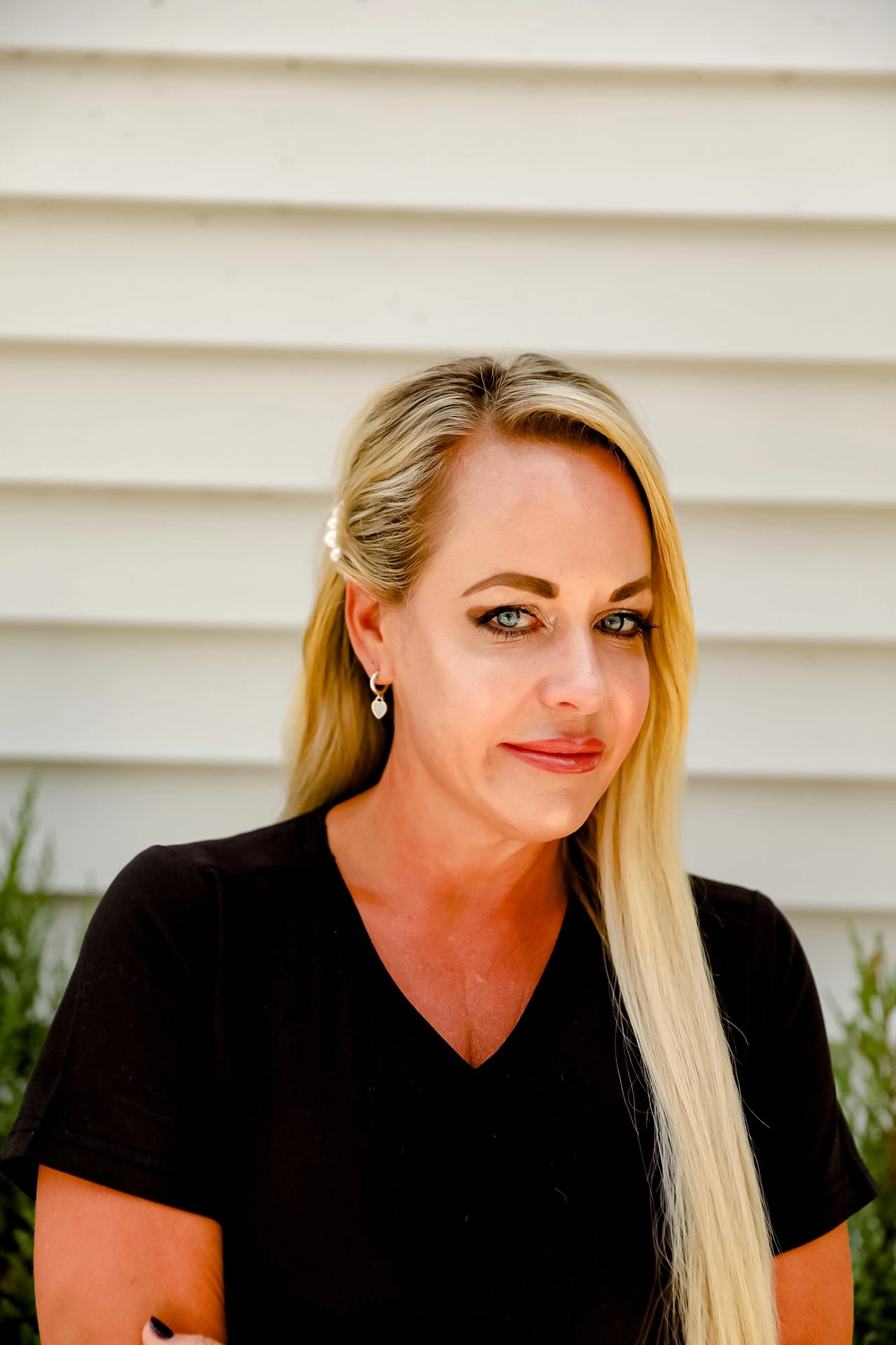 a woman with long blonde hair wearing a black shirt