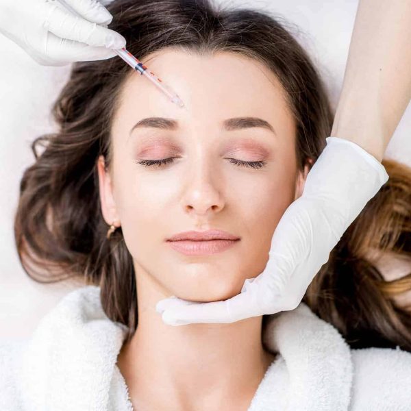 a woman receiving a botox injection