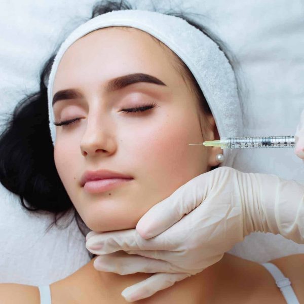 a woman receiving a botox injection