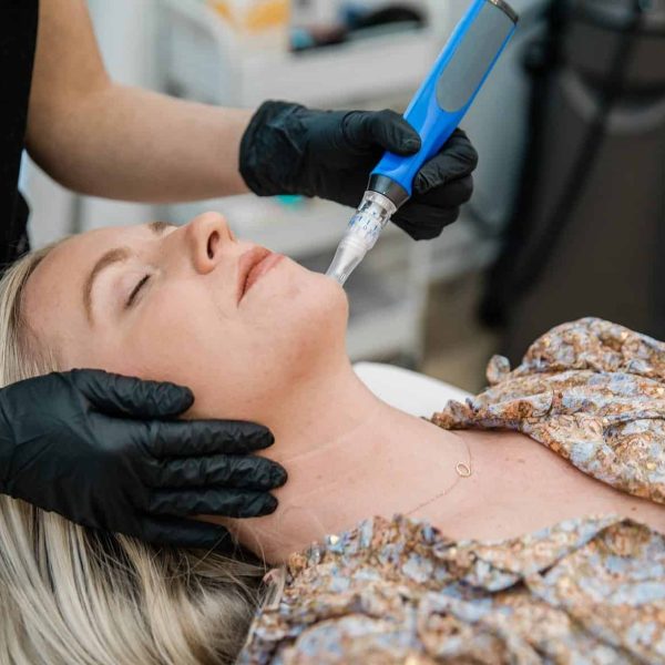 a woman receiving a facial massage